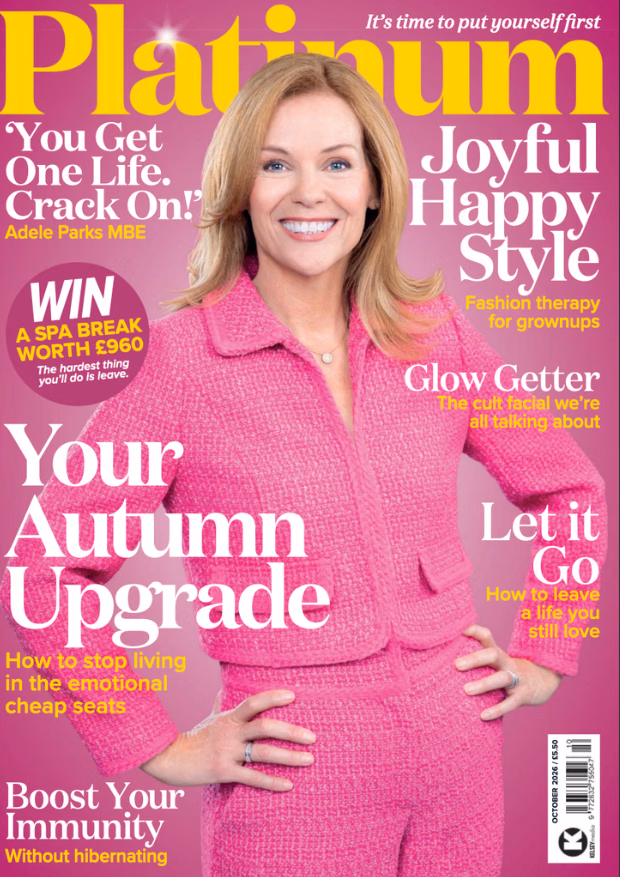 Cover of Platinum magazine, October 2026, featuring a smiling woman with shoulder-length blonde hair in a bright pink tweed suit, hands on