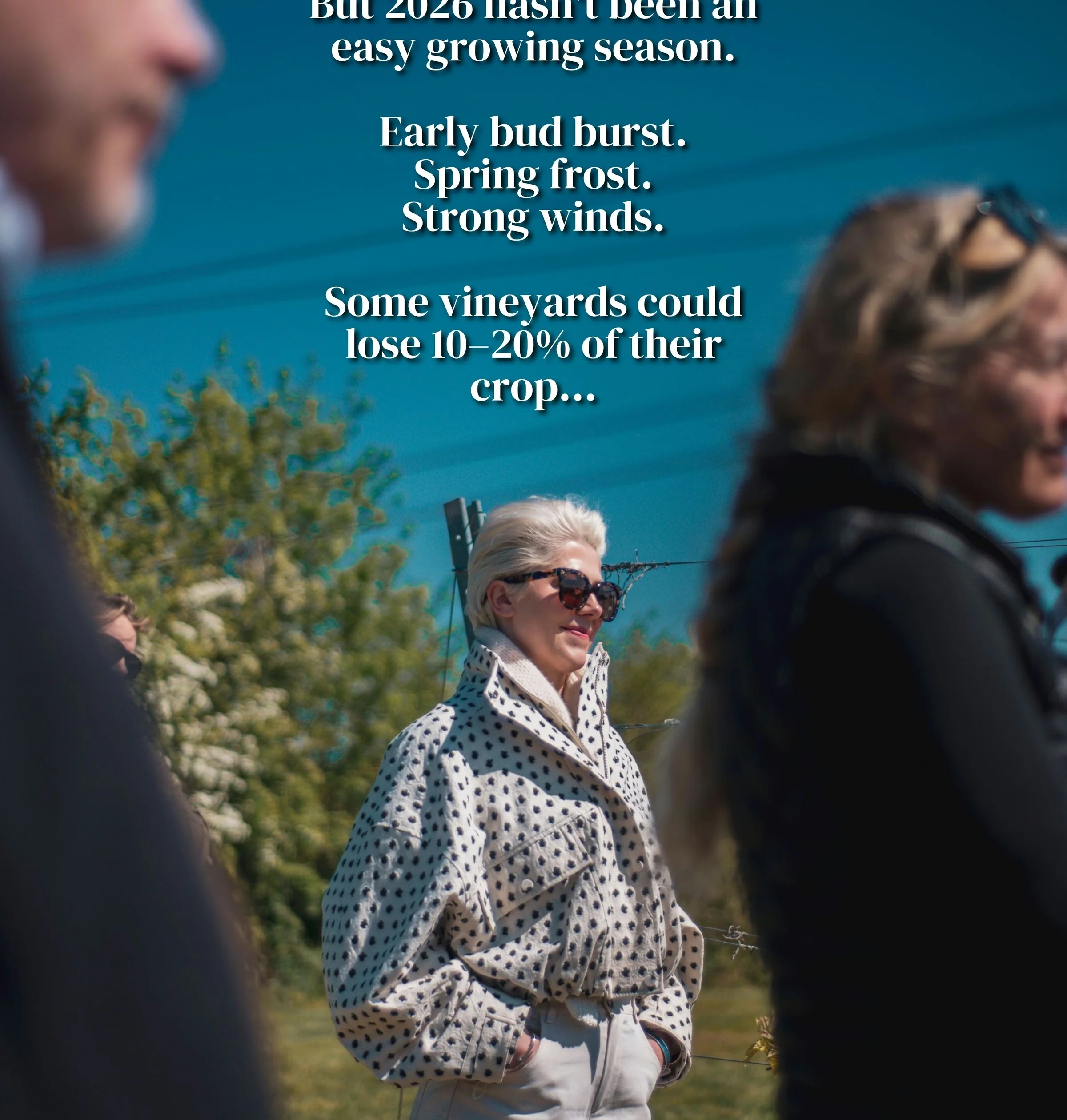 Visitors at an outdoor vineyard event beneath text about the difficult 2026 growing season