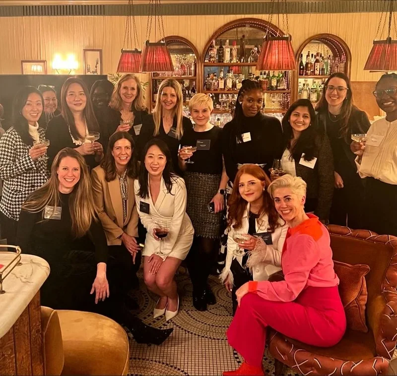 Group of women holding wine glasses at Kettner’s Champagne Bar during a Women in Wine event