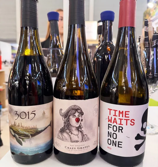 Three wine bottles displayed at Wine Paris, labelled 3015, The Original Crazy Grapes and Time Waits for No One
