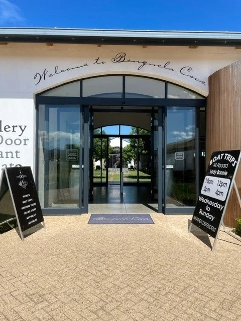 Entrance to Benguela Cove winery with signboards and glass doors