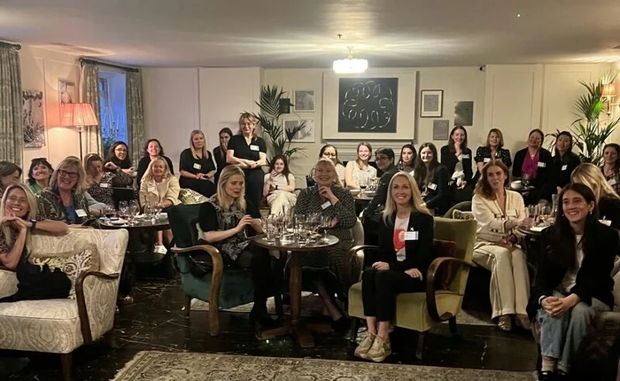 Women seated at tables during a wine event in London