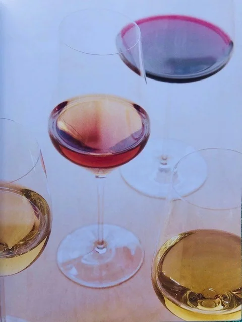Assorted wine glasses with red, white and rosé wine on table