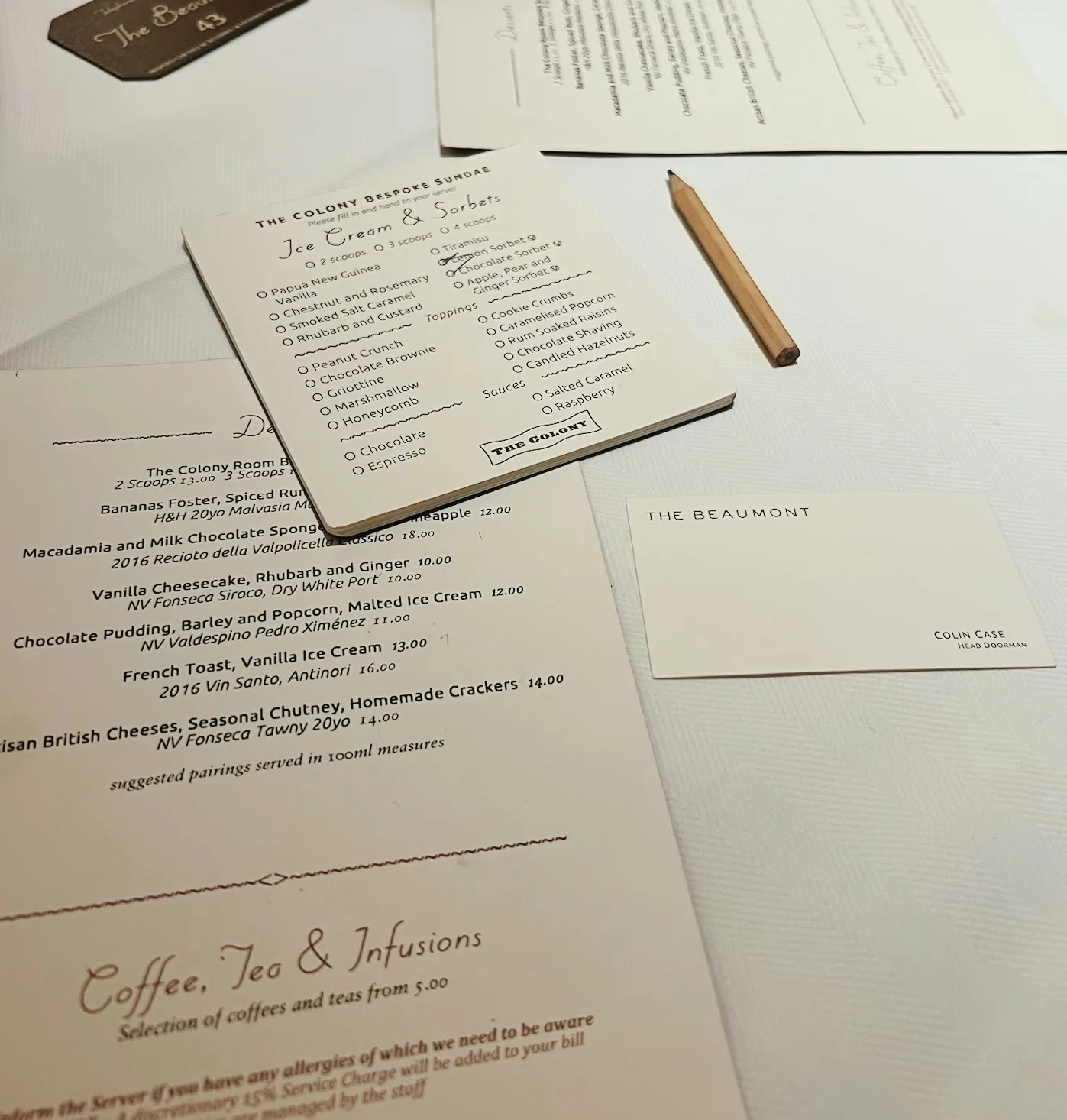 Menus and a blind tasting card for ice cream and sorbets on a restaurant table, with a pencil and The Beaumont card
