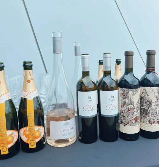 Selection of wine bottles and glasses arranged on a tasting table
