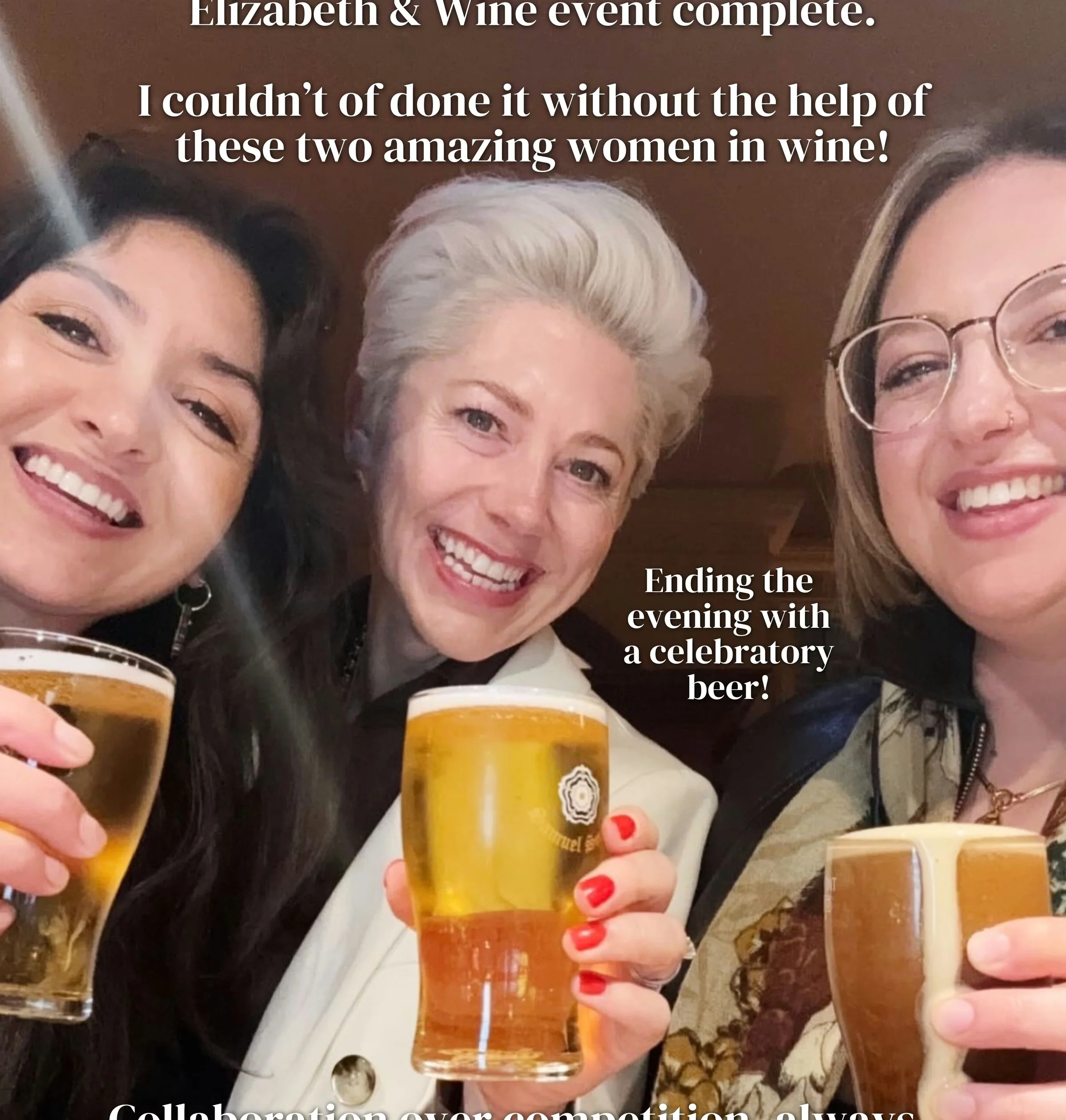 Three women smiling and raising pints in a pub