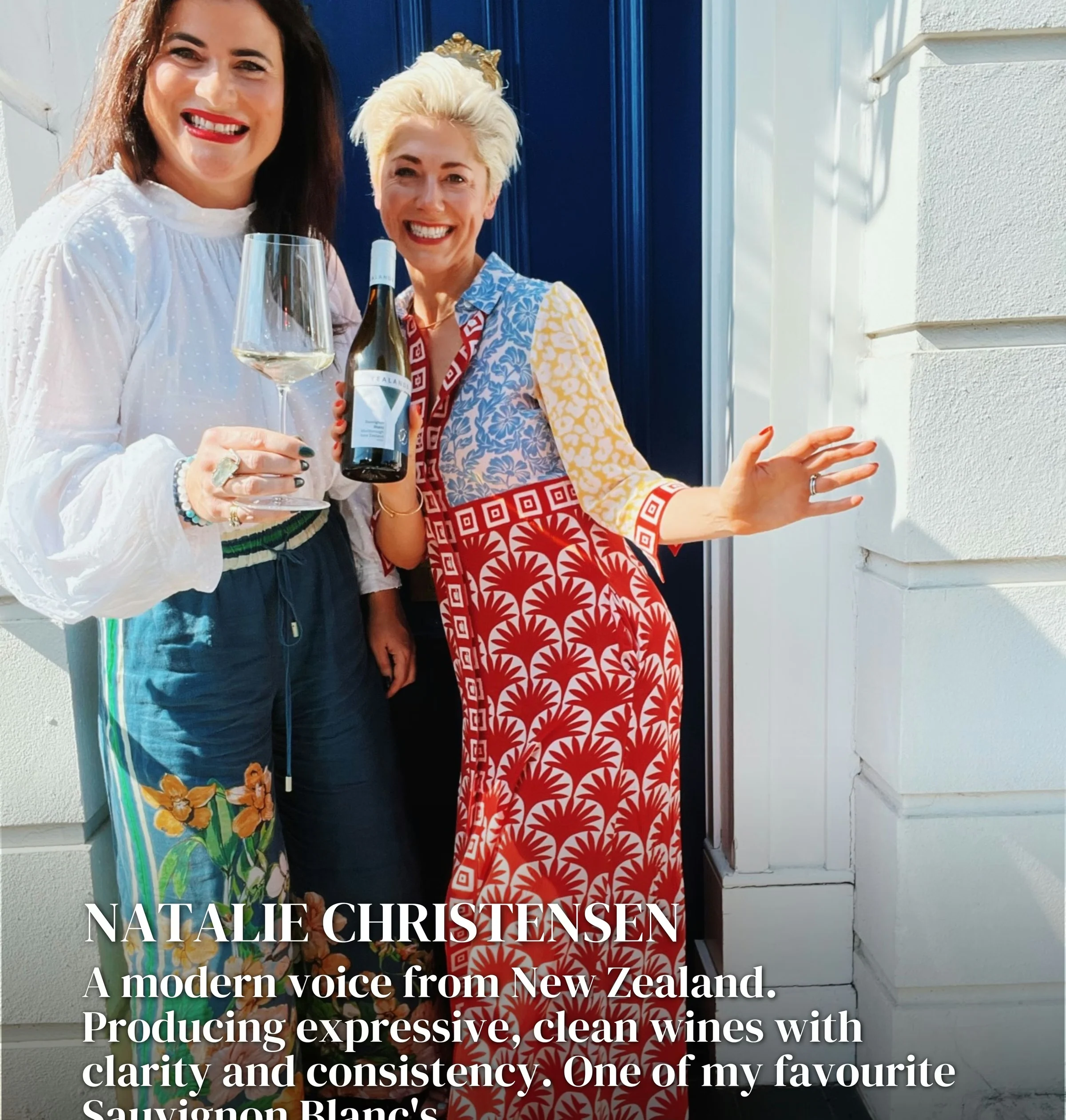Two women at a doorway, holding a wine glass and bottle beneath text about Natalie Christensen