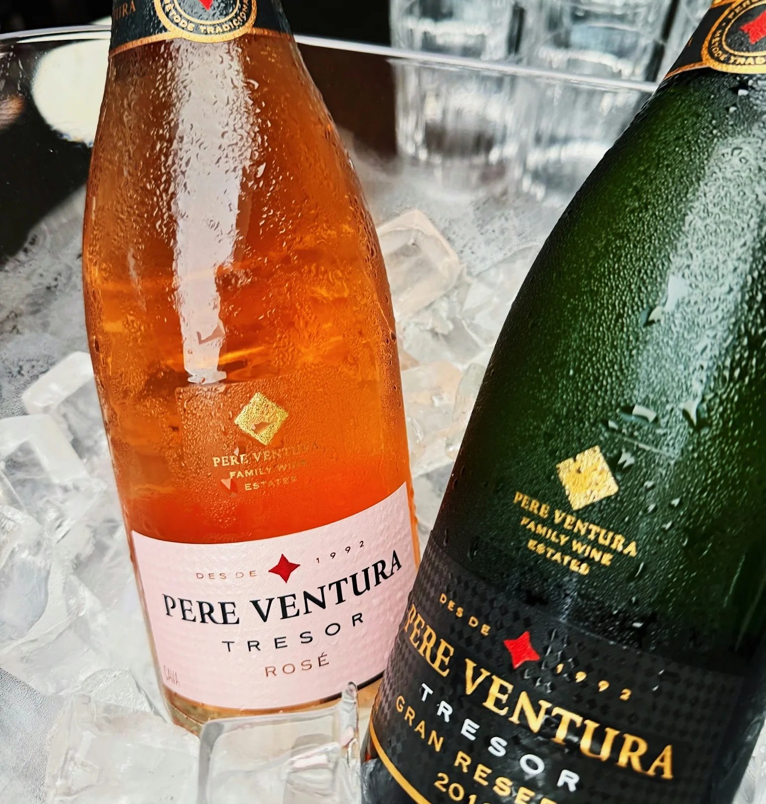 Chilled Pere Ventura rosé and Gran Reserva sparkling wine bottles displayed on ice