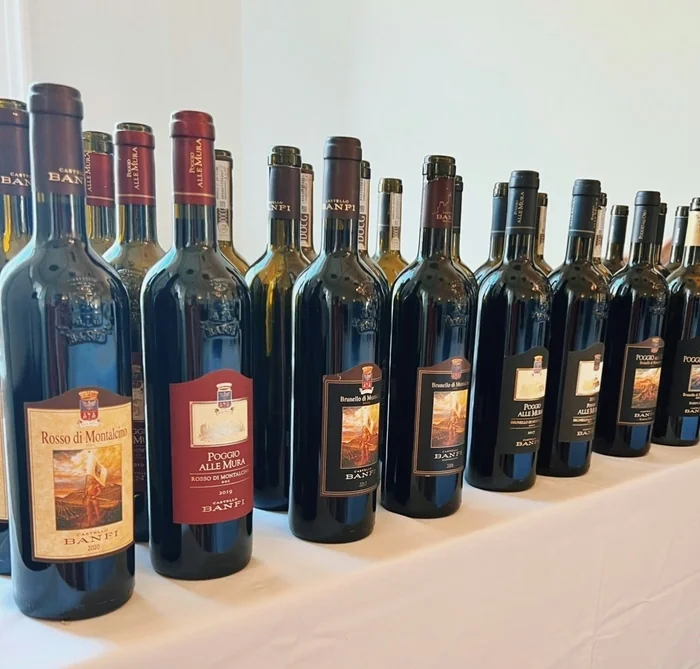 Rows of Castello Banfi wine bottles arranged on a white table