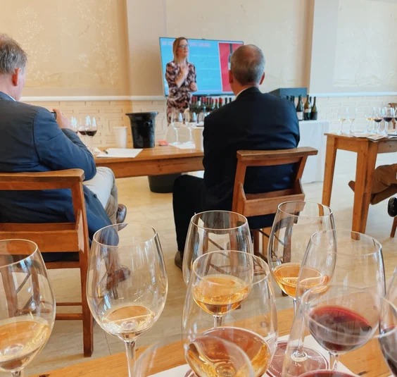 Wine tasting with several glasses in the foreground and a presentation on screen
