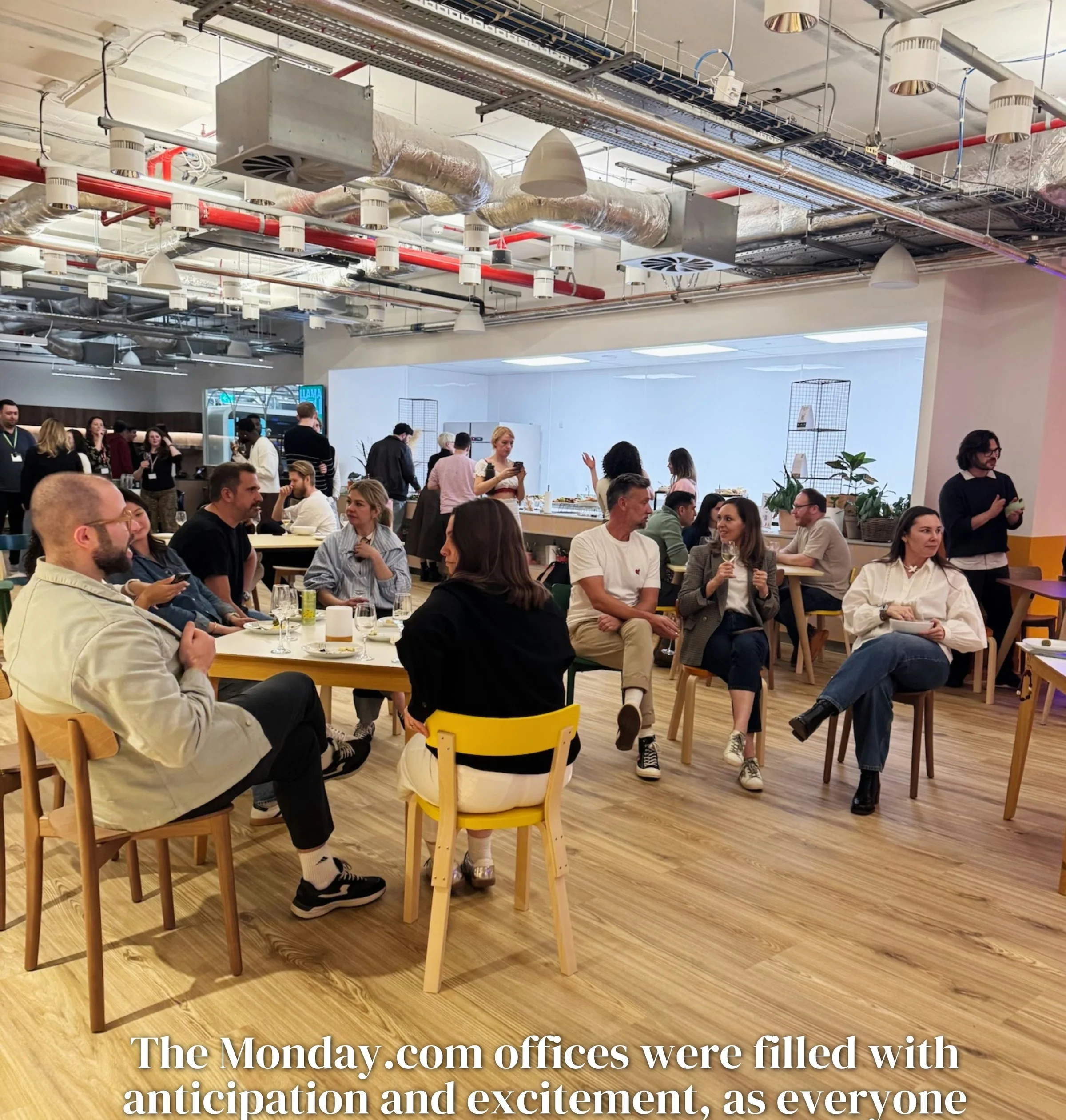 Colleagues gather for a wine tasting in a bright, modern office dining space