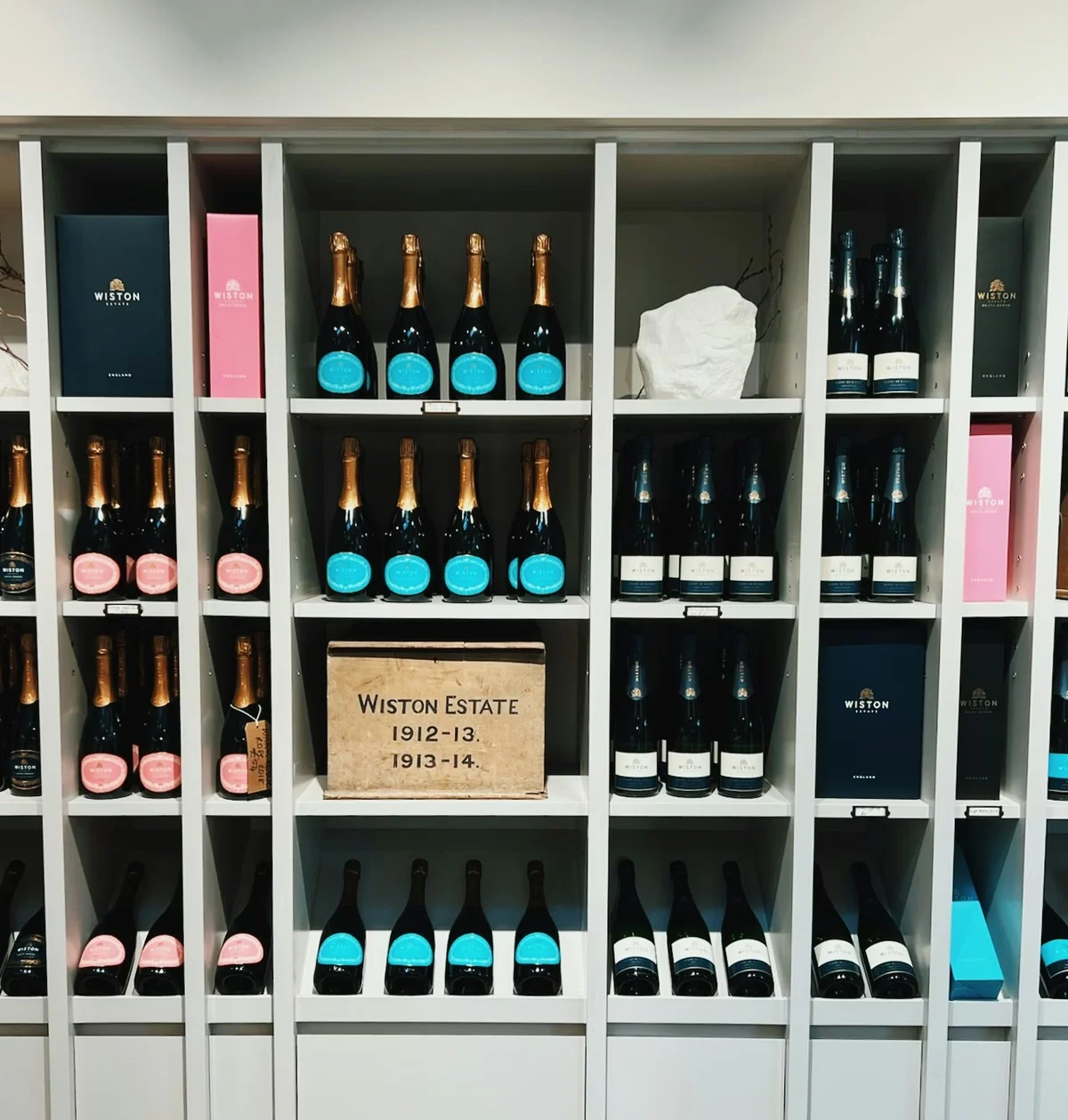 Shelves displaying Wiston Estate sparkling wine bottles and gift boxes