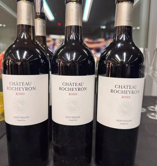 Three bottles of Château Rocheyron 2010 Saint-Émilion Grand Cru on a table