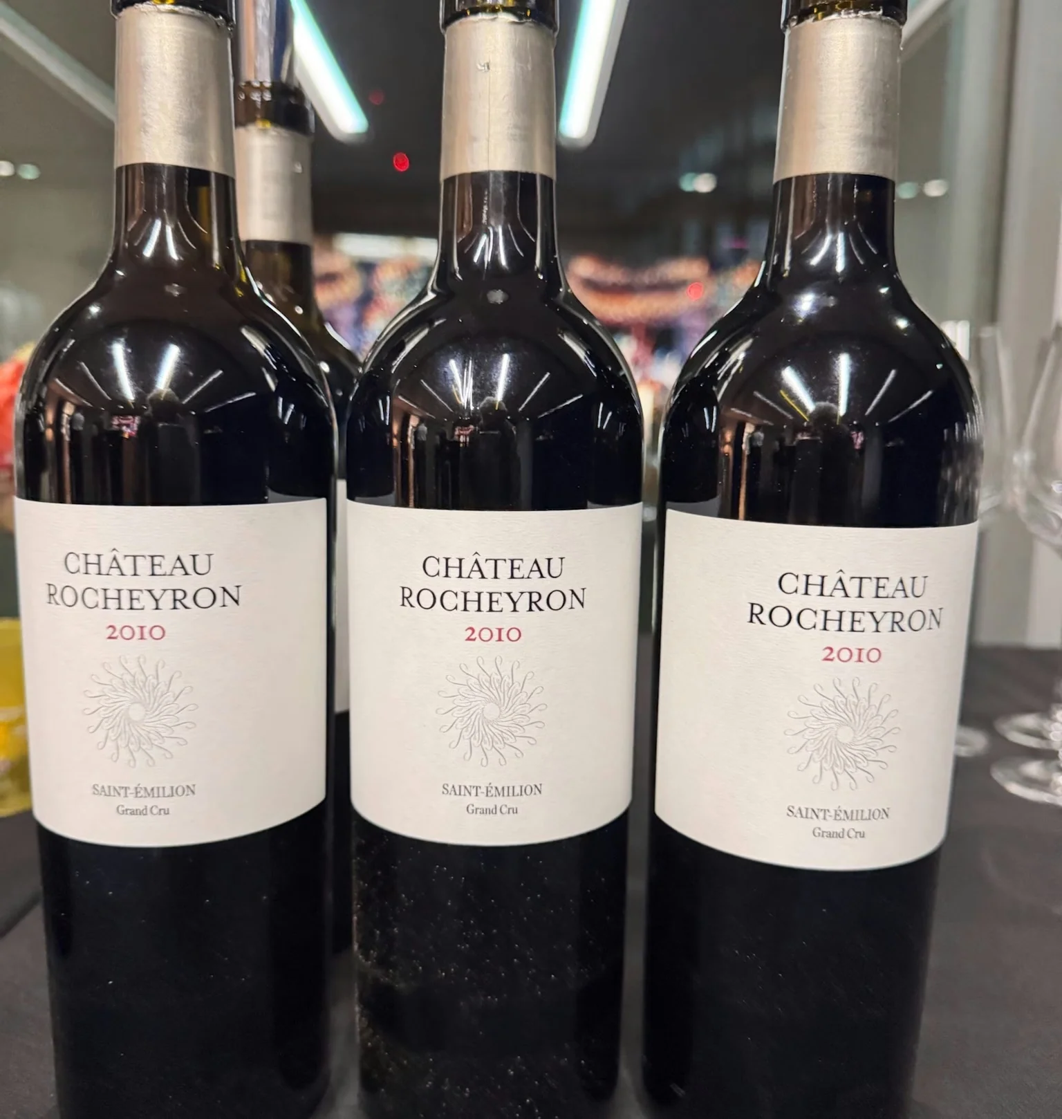 Three bottles of Château Rocheyron 2010 Saint-Émilion Grand Cru on a table