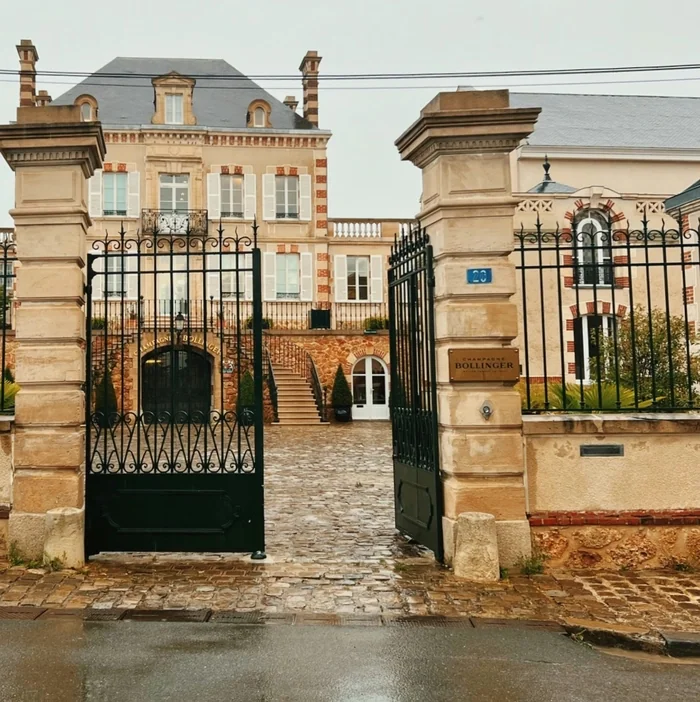 Entrance to Champagne Bollinger, with ornate gates and a grand building at number 20.