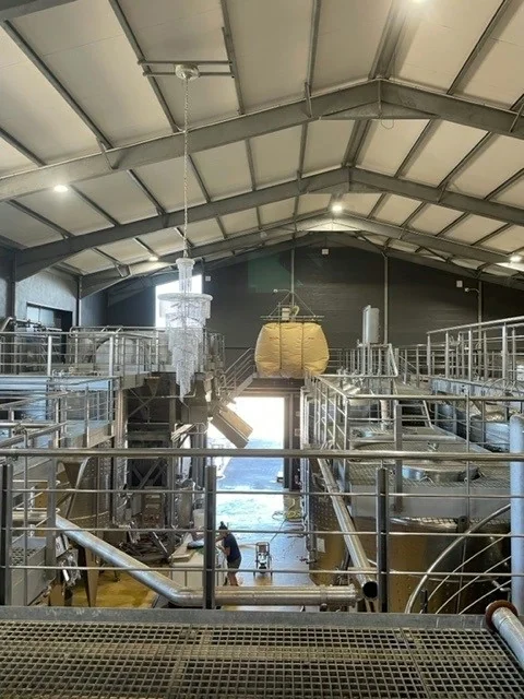 Industrial wine cellar with stainless steel tanks and catwalks