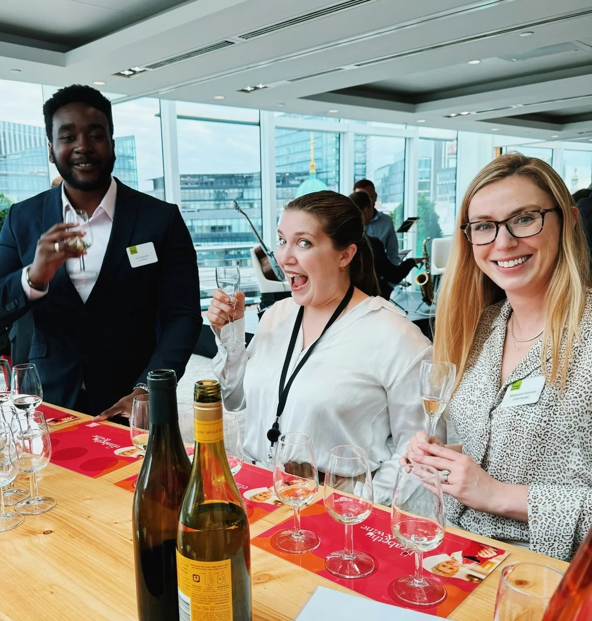 Guests raise wine glasses at a corporate tasting in a bright London venue