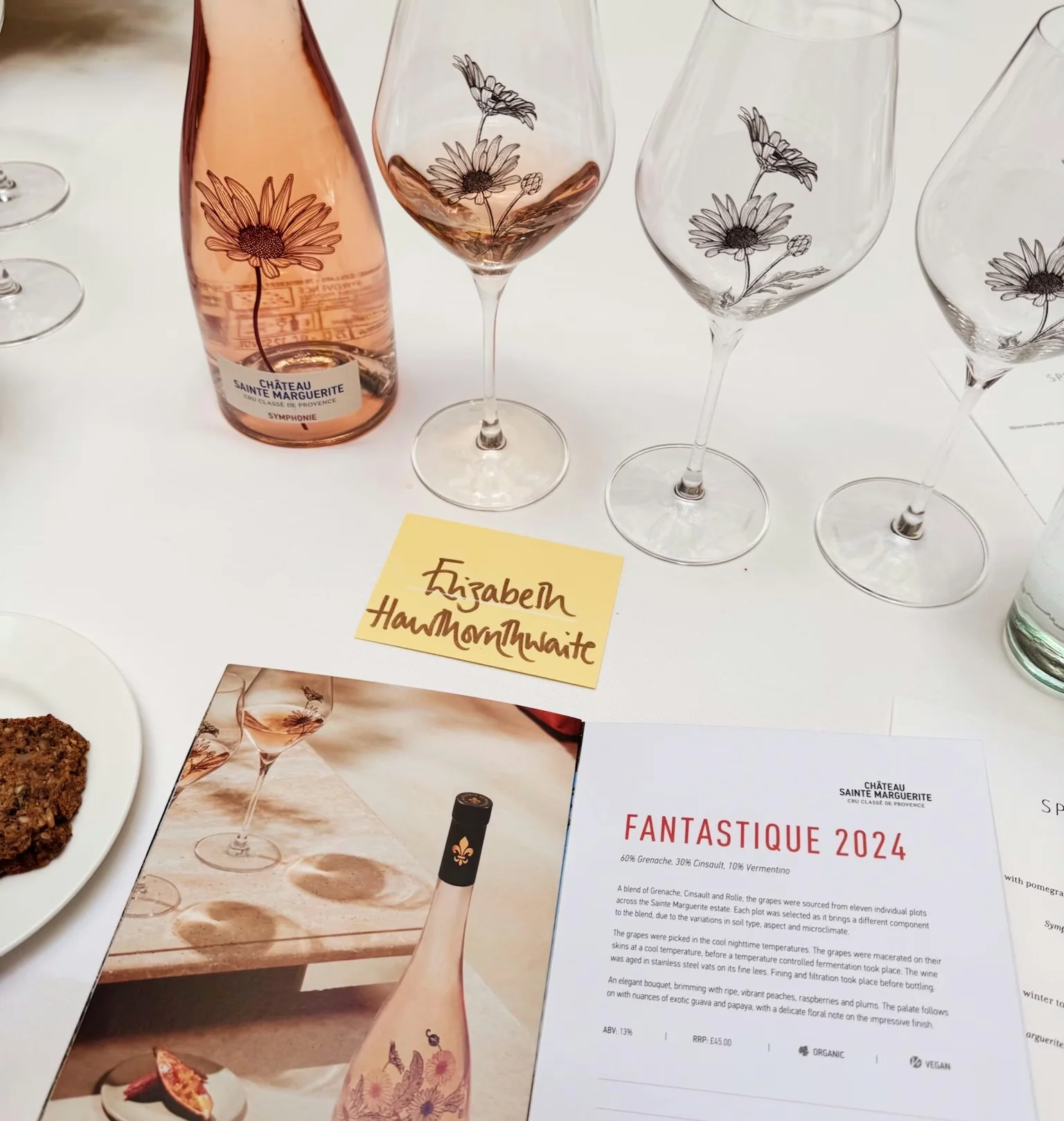 Rosé wine, three floral-printed glasses, flowers and a menu for Château Sainte Marguerite’s Fantastique 2024