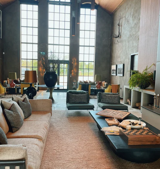 Exton Park tasting room with tall windows, sofas, tables and exposed chalk wall