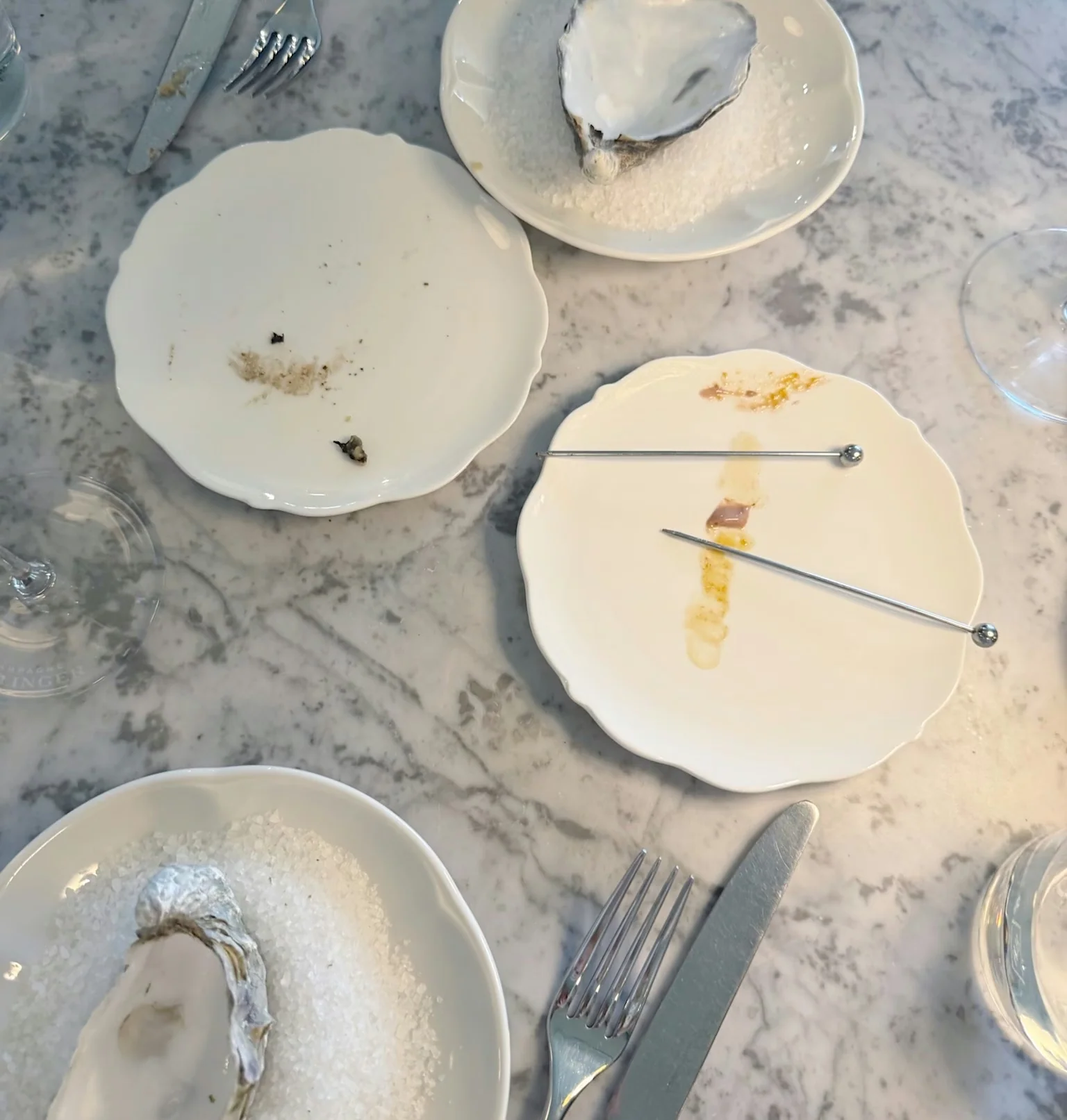 Oyster dishes and tasting plates on a marble table