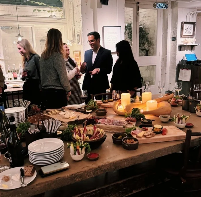 Guests mingling beside a gourmet wine tasting table in London