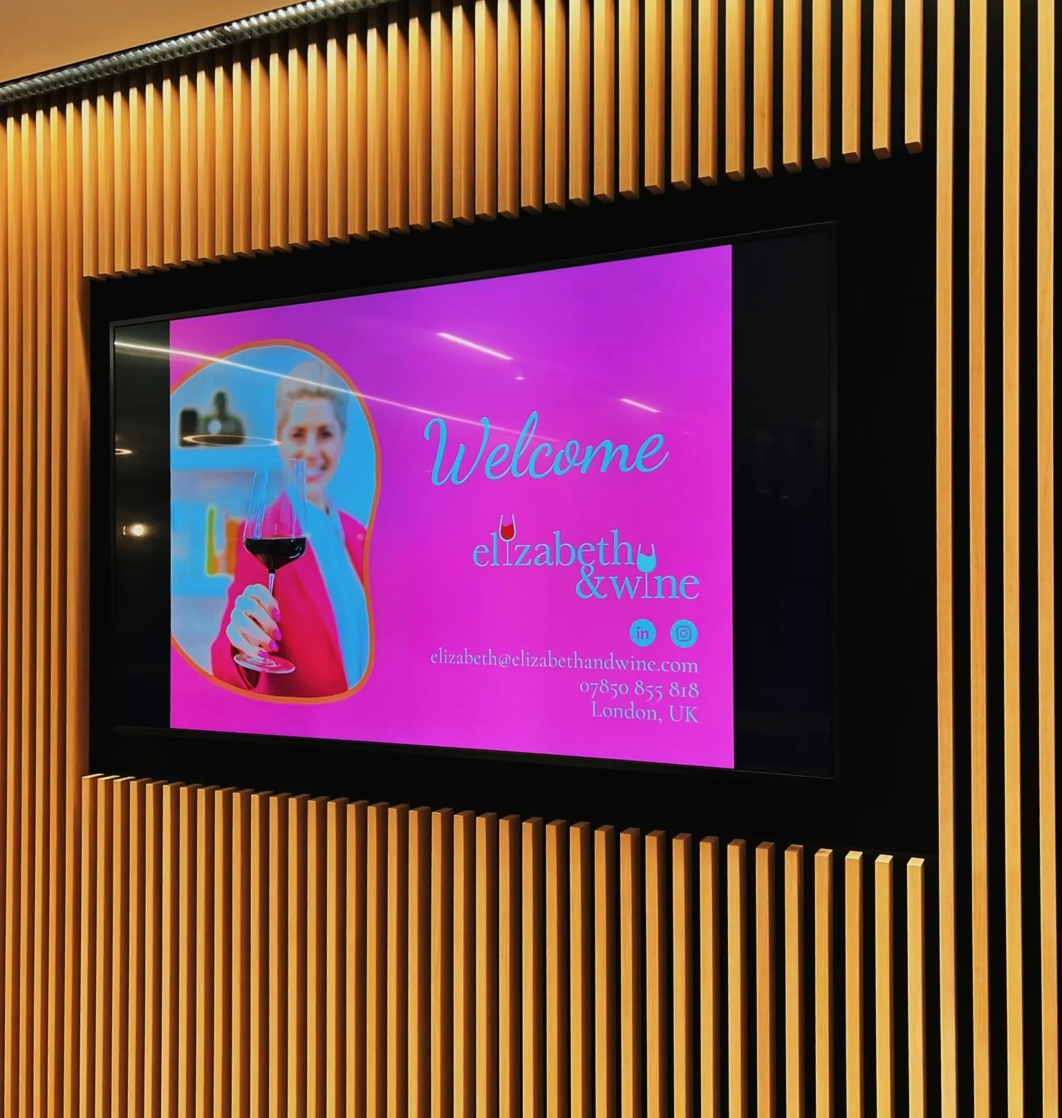 Welcome screen for Elizabeth & Wine displayed on a wood-panelled wall