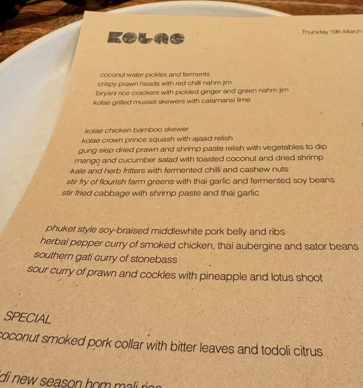 Kolae restaurant menu beside sunglasses and a white plate