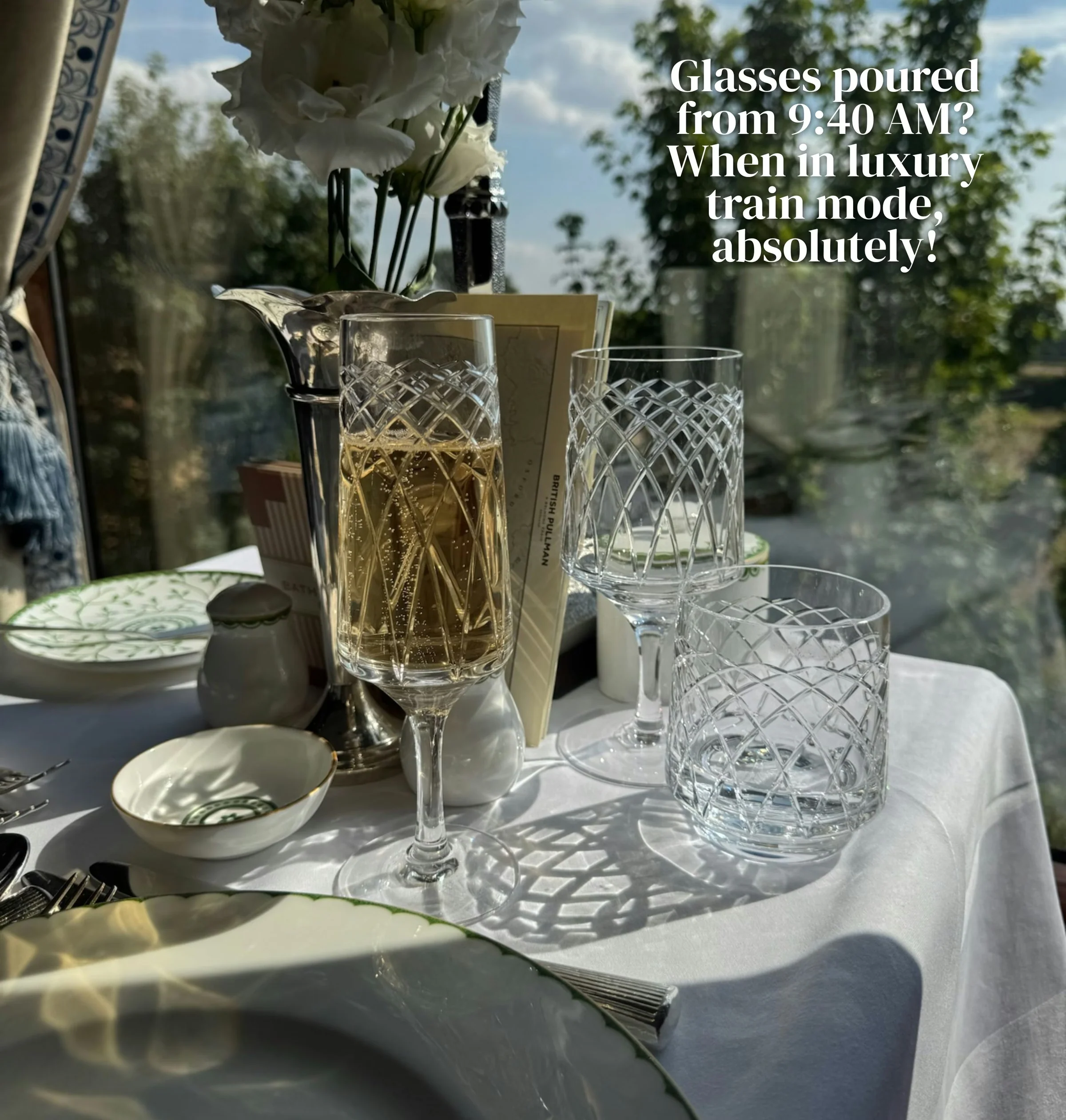 Champagne and crystal glasses on a fine dining table aboard a luxury train