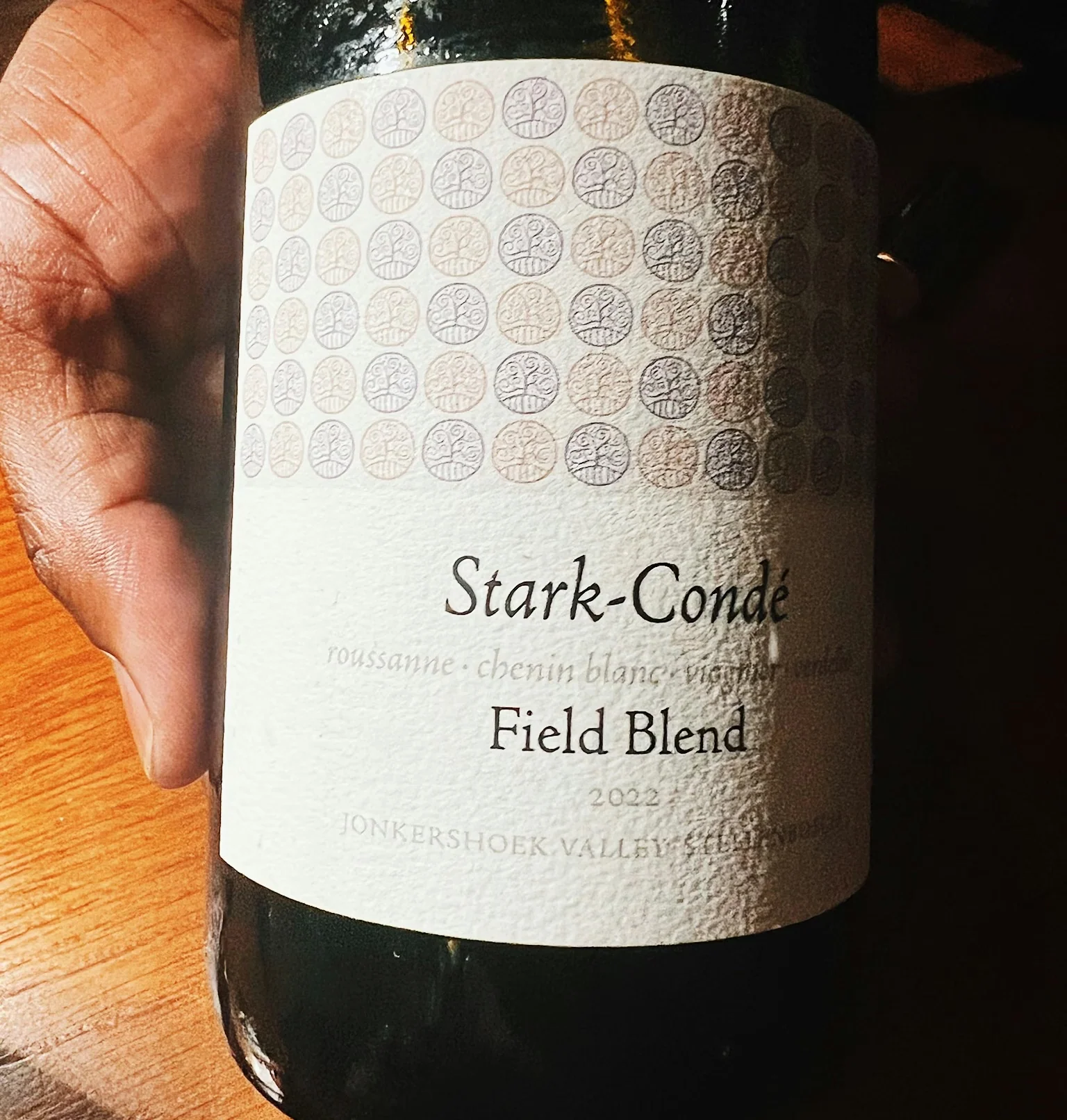 Stark-Condé Field Blend 2022 wine bottle on a wooden table