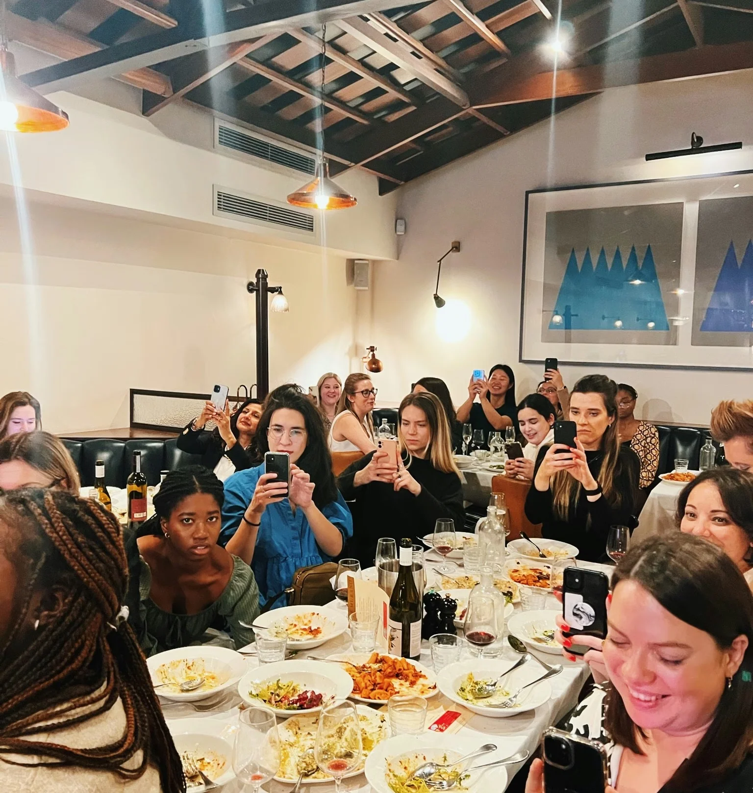 Guests enjoy a wine-filled dinner in a warmly lit restaurant