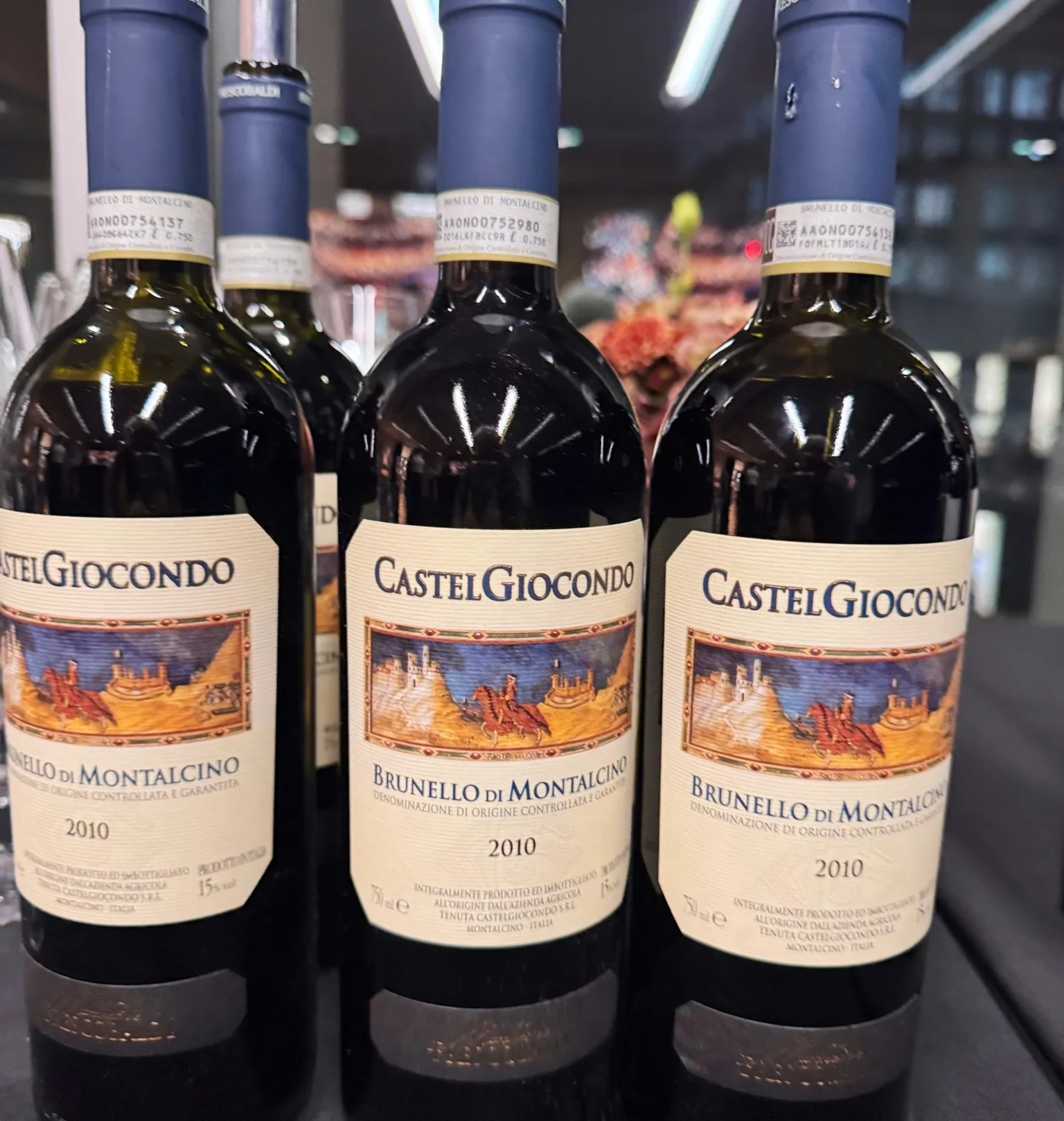 Three bottles of CastelGiocondo Brunello di Montalcino 2010 at a wine tasting