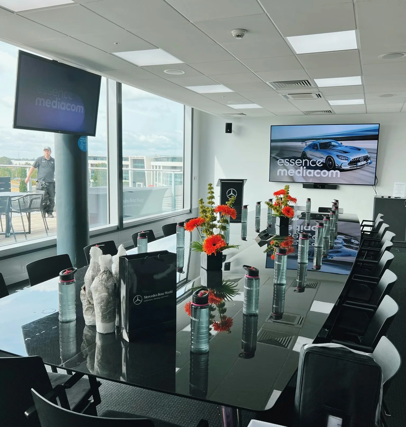 Corporate tasting table set with flowers and branded water bottles at Mercedes-Benz World