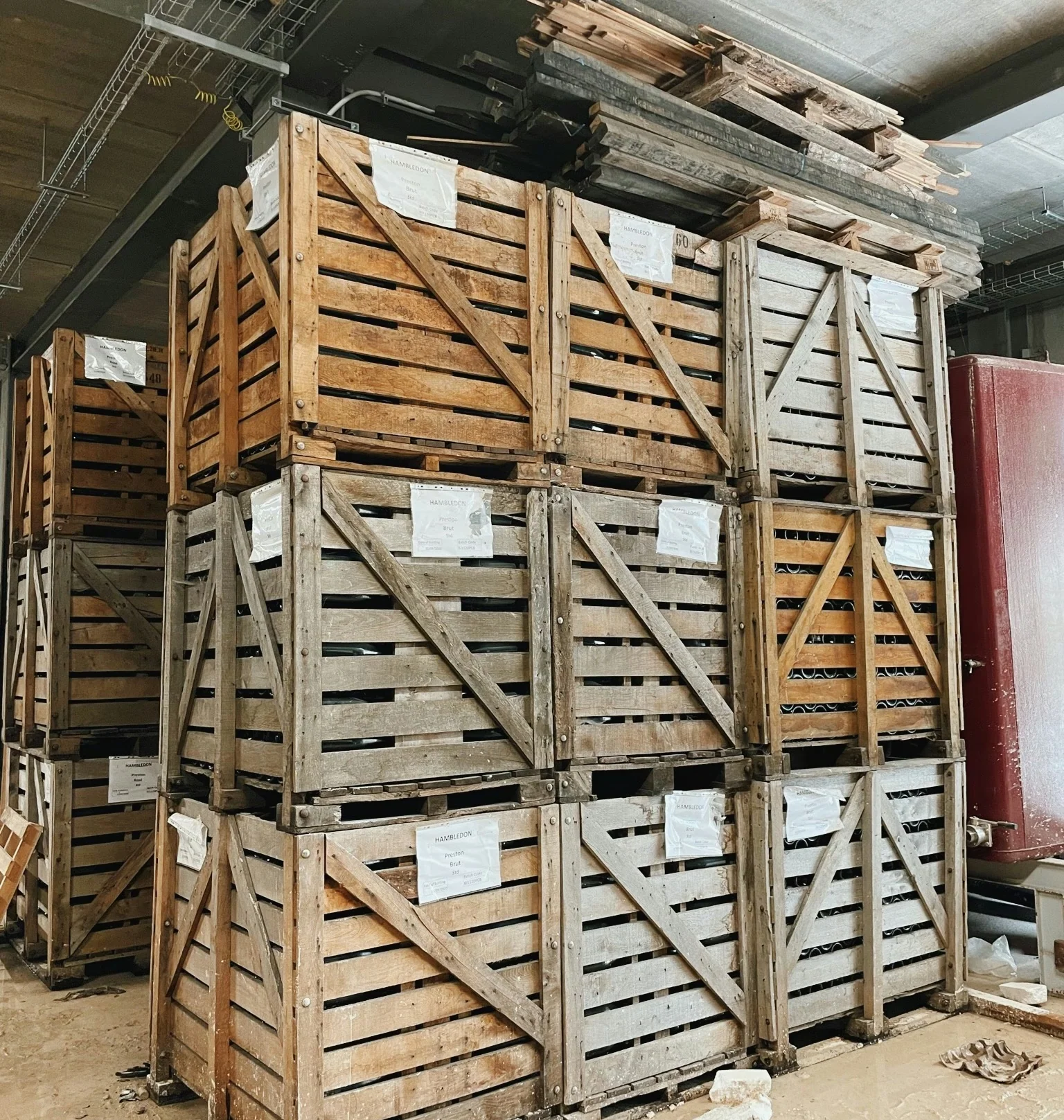 Stacked wooden wine crates labelled Hambledon in a winery storage area