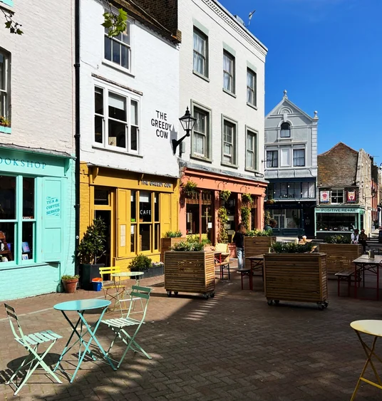 Colourful cafés and shops around an outdoor seating area in Margate