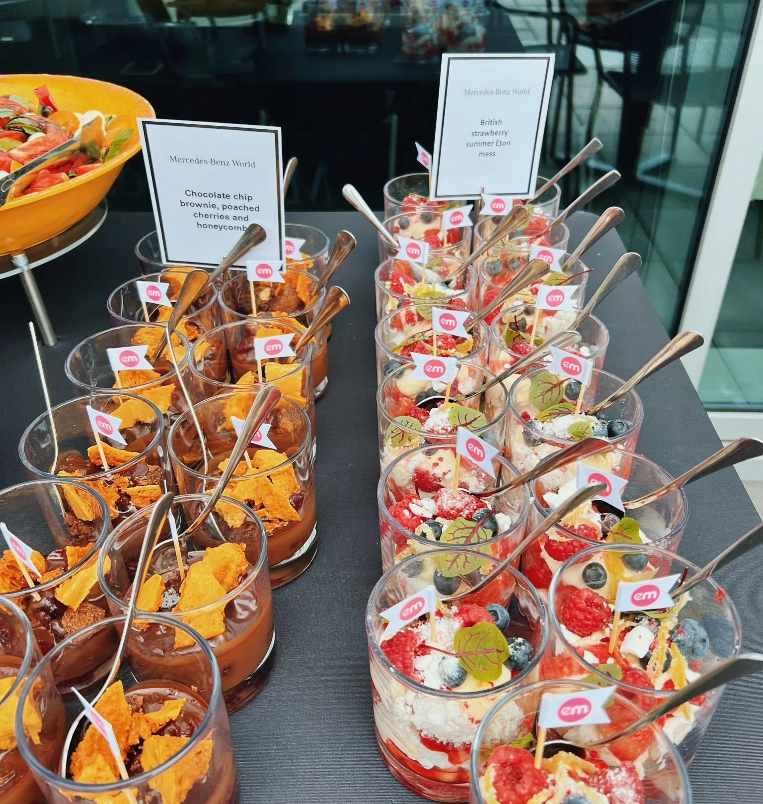 Dessert glasses labelled chocolate brownie and British strawberry summer Eton mess