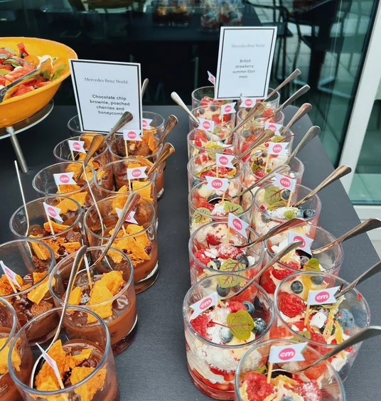 Dessert glasses labelled chocolate brownie and British strawberry summer Eton mess