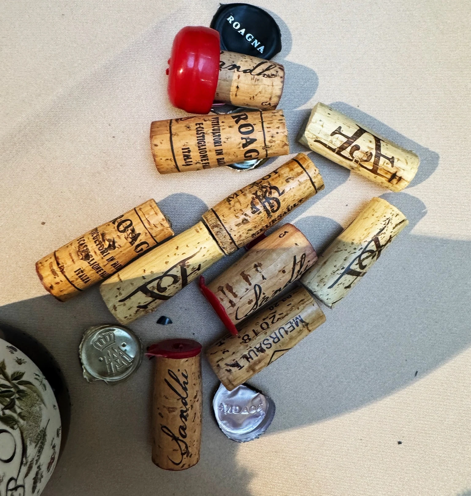 Wine corks, capsules and a corkscrew scattered on a table during an office wine tasting