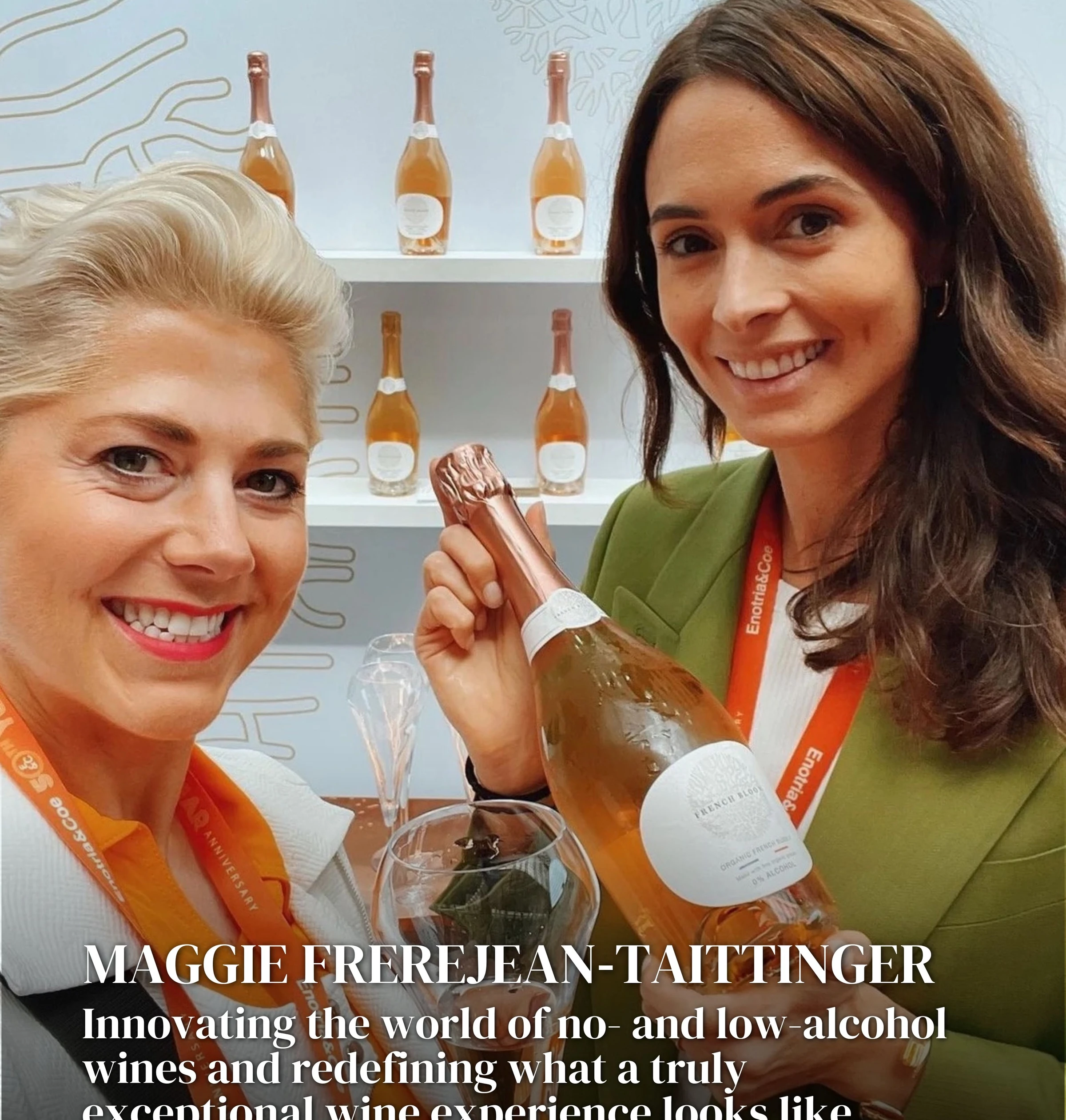 Two women pose with a bottle of French Bloom sparkling wine at a tasting event