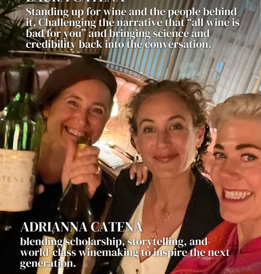 Three women pose with a wine bottle beneath text about Laura and Adrianna Catena