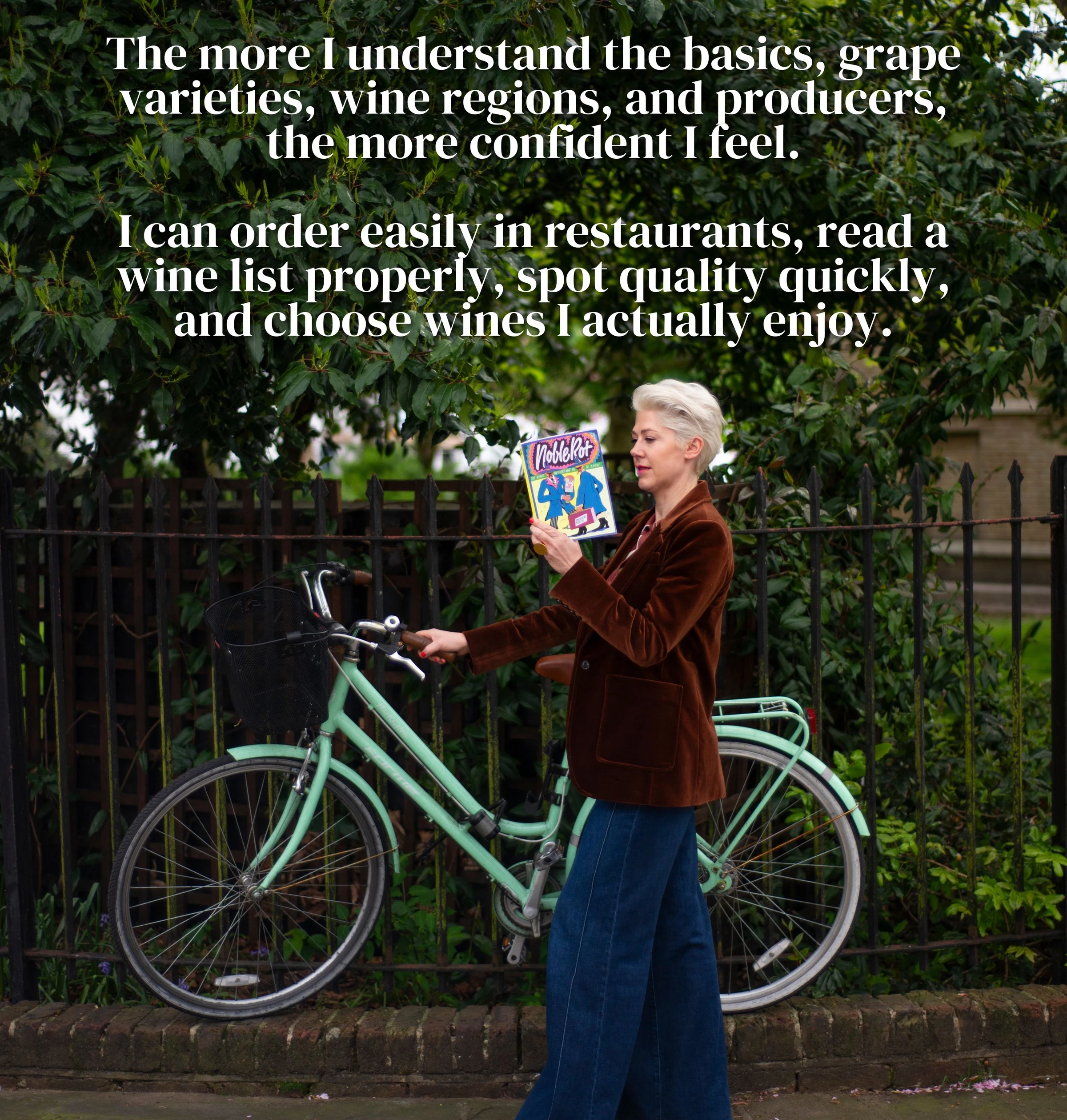 Woman in a brown jacket holding a wine magazine beside a mint-green bicycle