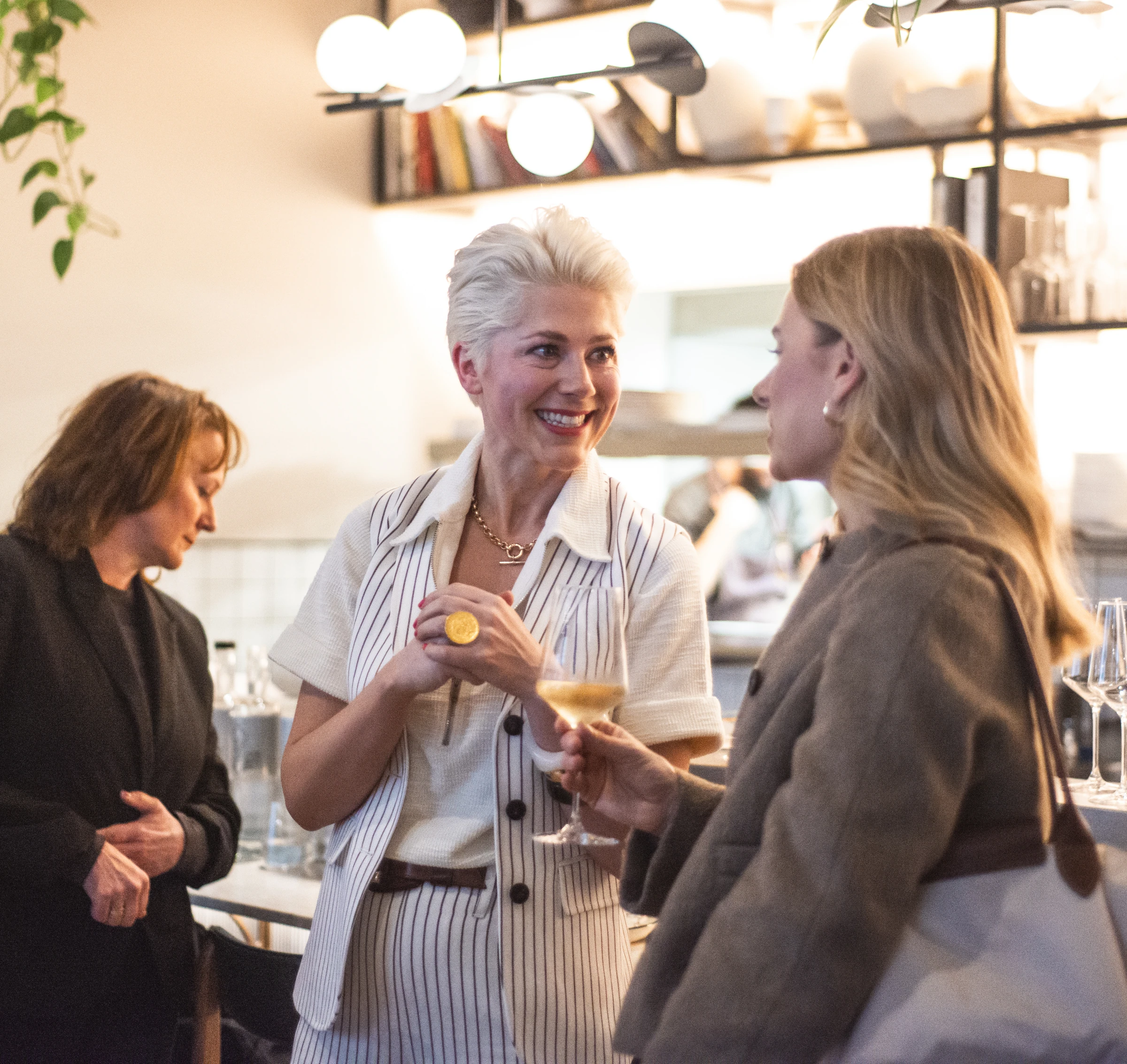 Guests chat over wine at a tasting event in a modern restaurant