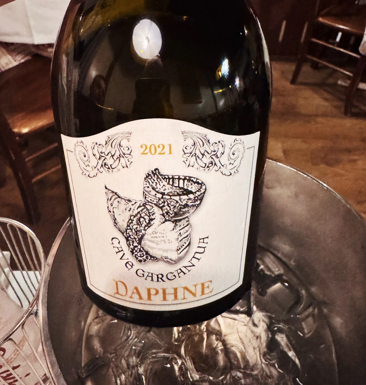 Bottle of 2021 Daphne Canèva Garganega wine on a restaurant table in Champoluc