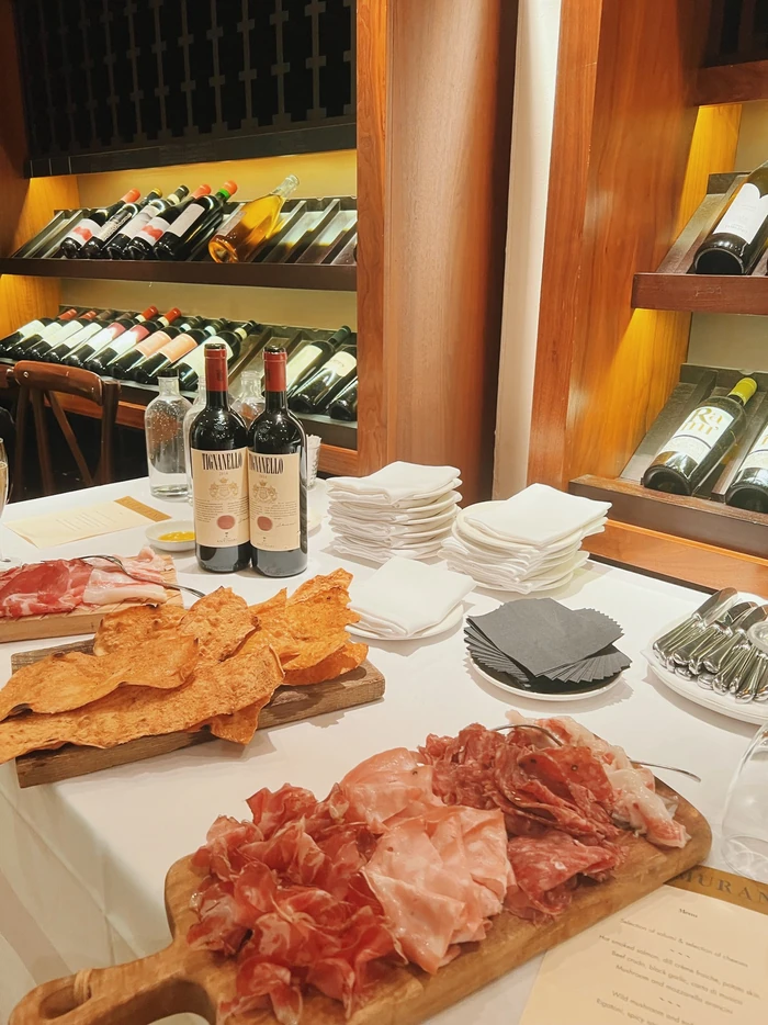 Wine bottles and charcuterie served on a table at Cafe Murano