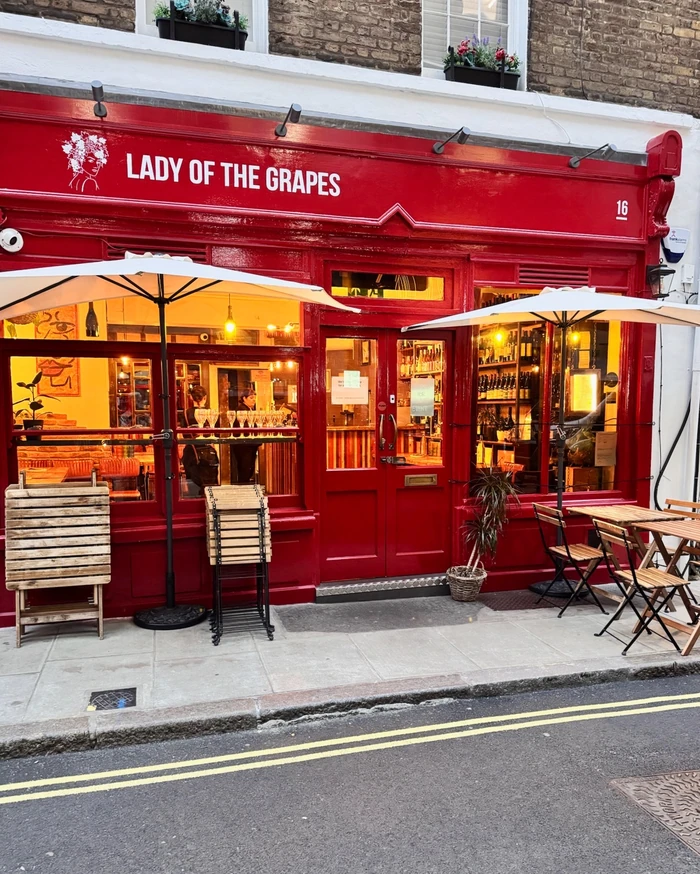 Red Lady of the Grapes wine bar frontage with outdoor tables and umbrellas