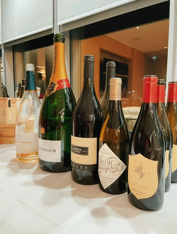 A selection of wine bottles, including Bollinger Champagne, Barolo and Californian red wine, on a drinks table