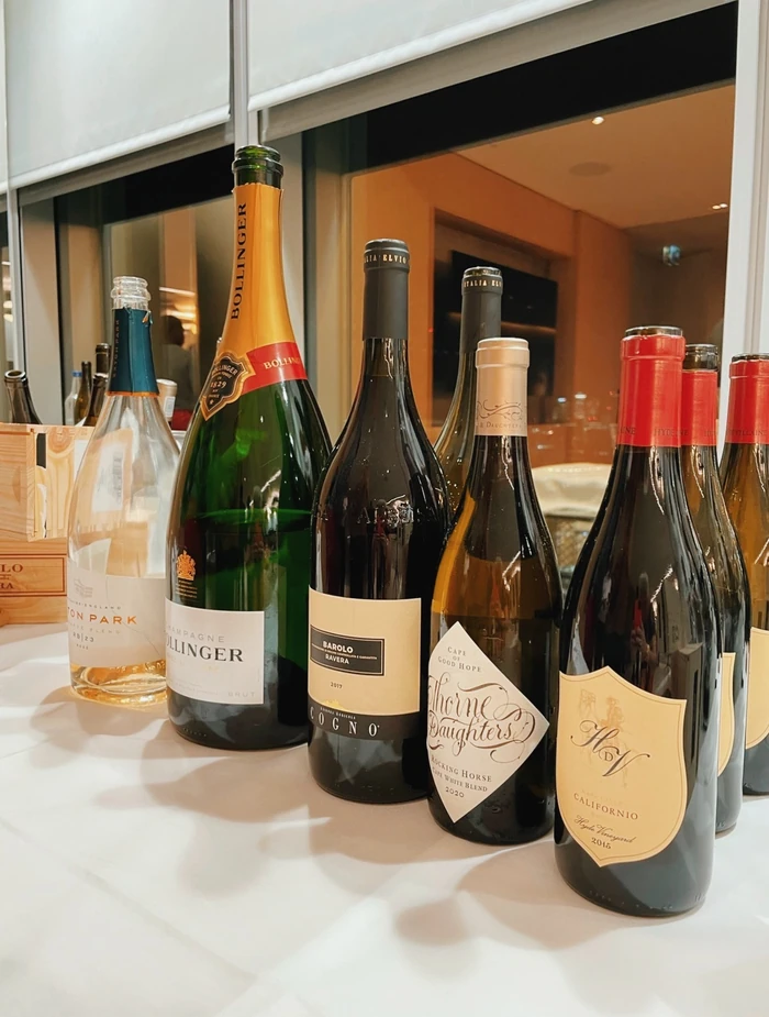 A selection of wine bottles, including Bollinger Champagne, Barolo and Californian red wine, on a drinks table