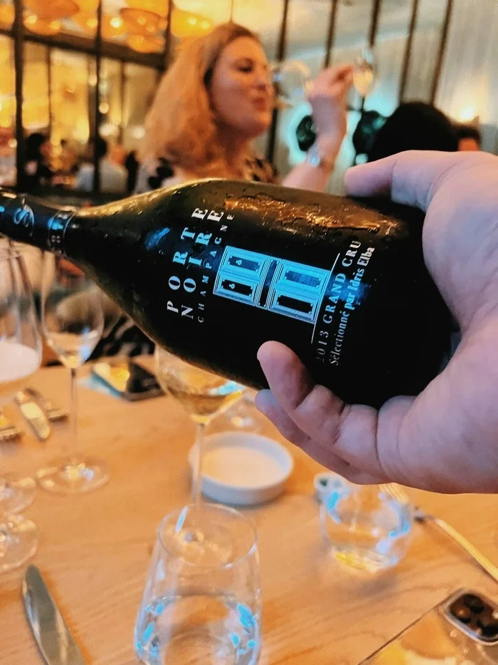 Bottle of Porte Noir Champagne being poured at a wine tasting table