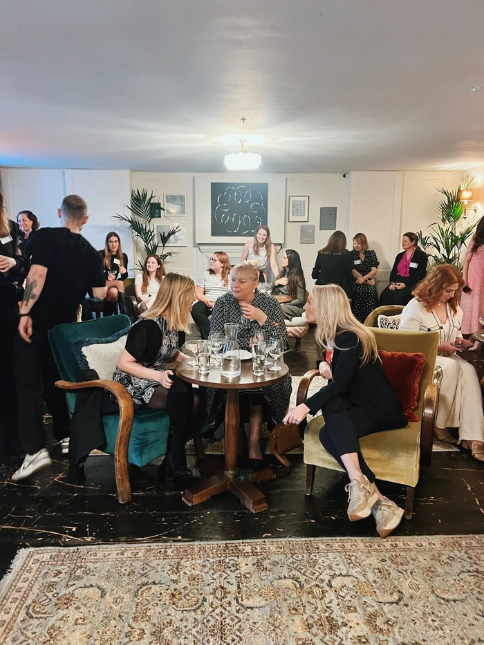 Women gathered around a table with wine glasses at a private tasting event