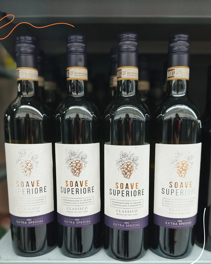 Four bottles of Soave Superiore Classico wine displayed on a shelf
