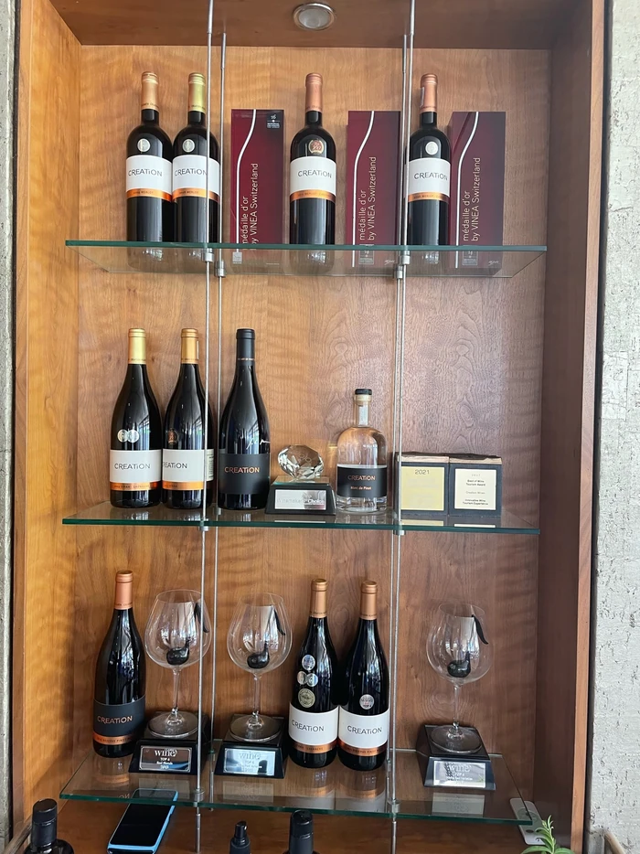 Display cabinet of Creation wine bottles, glasses and wine awards